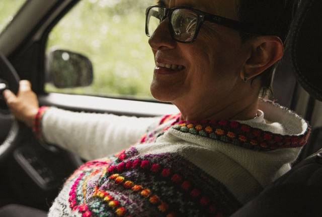 Woman smiling in her Motability car enjoying the benefits of Motability.