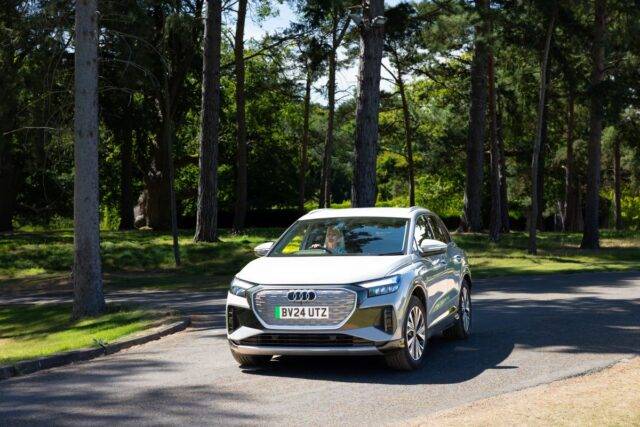 electric cars for disabled blog - mature lady driving Audi Q4 E-Tron through country road