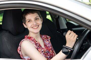 Judith King, a Mobility in Motion customer, sat in the driver's seat of her car using the Brig-Ayd Tetra Grip